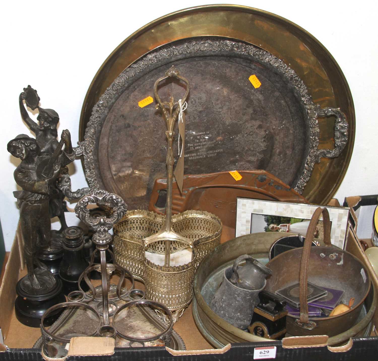 A collection of miscellaneous items to include spelter figures, silver plated bottle stand, and