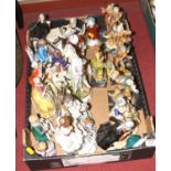 A collection of continental porcelain and resin figure groups and figures