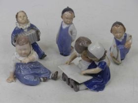 Four Royal Copenhagen porcelain figures of boys, largest height 12cm, together with a Bing &