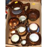 A collection of Victorian copper lustre ceramics to include jugs, and tea cups