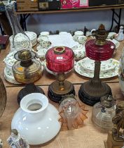 A collection of Victorian oil lamp parts, to include shades, fonts, and bases