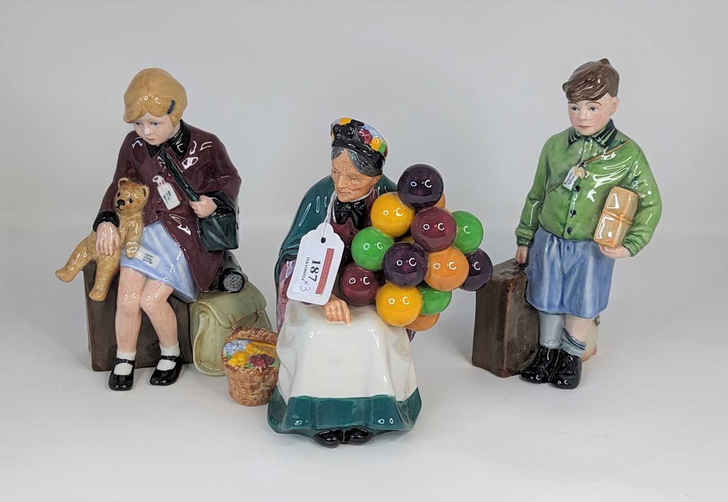 A Royal Doulton figure The Old Balloon Seller, together with The Boy Evacuee, and The Girl