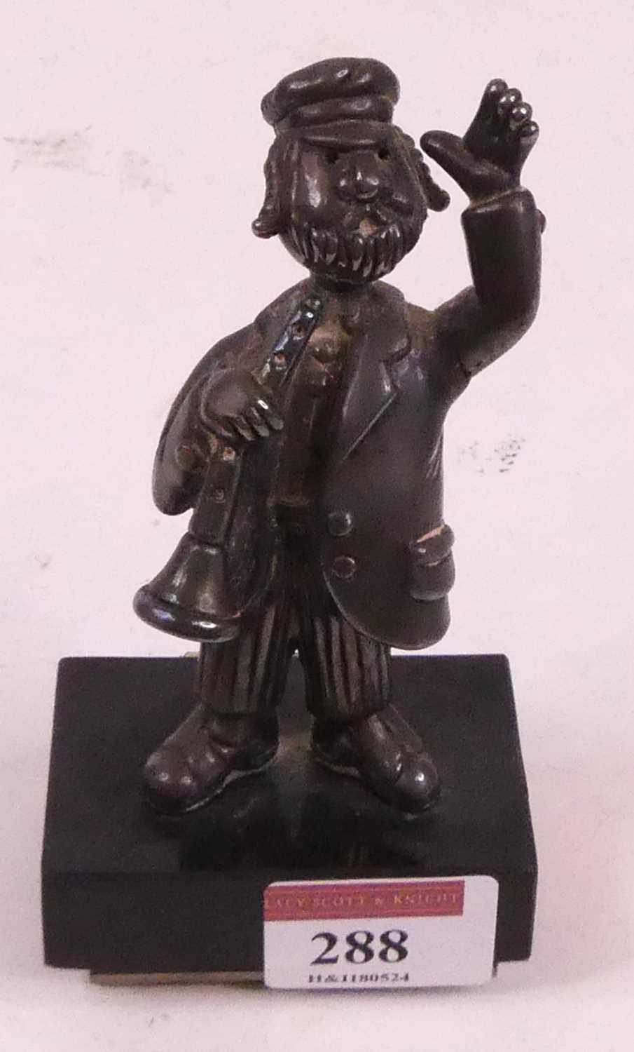 A Frank Meisler of Israel white metal figure of a musician, mounted upon a polished hardstone