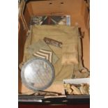 A collection of militaria, to include brass buttons, cap badges, arm band etc