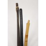 An Asian bent bamboo long bow, length 219cm, together with a hardwood example, and a hardwood