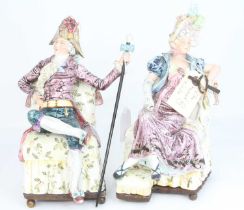 A pair of continental pottery figures, each shown reclining in 18th century dress, largest height