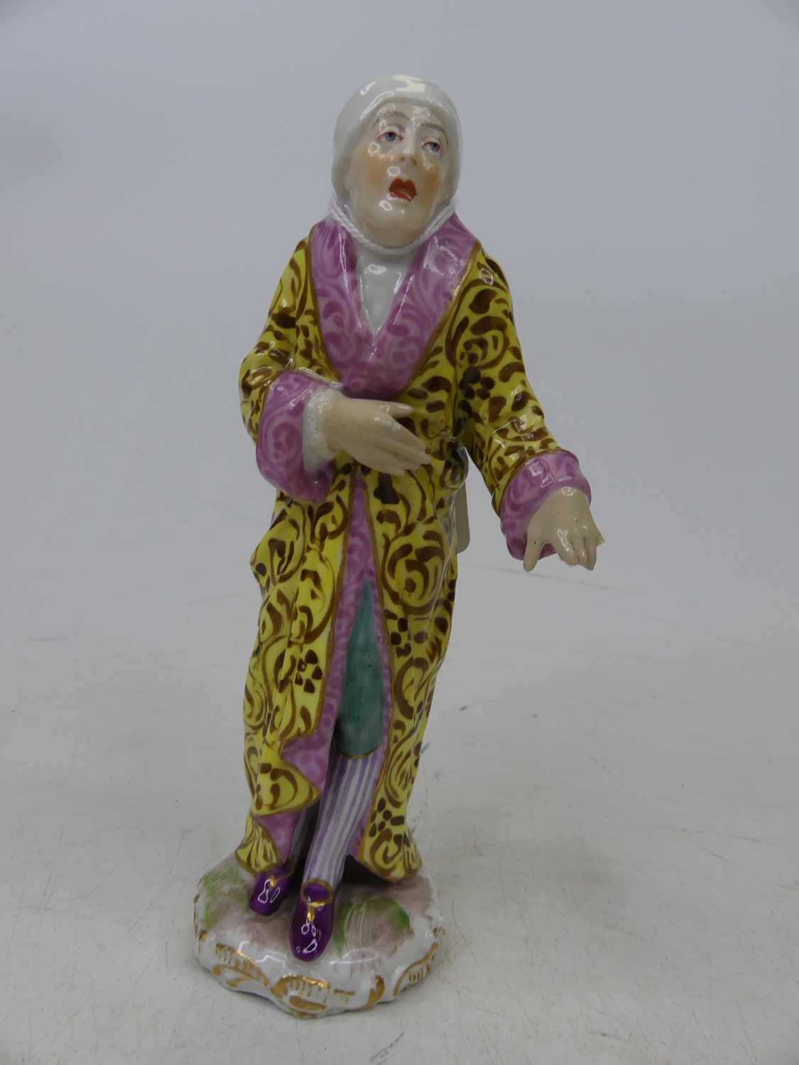 A 19th century German porcelain figure, height 17cm, together with a pair of white glazed pottery - Image 2 of 3