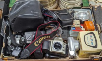 A collection of vintage cameras to include examples by Sigma, Nikon, and Canon