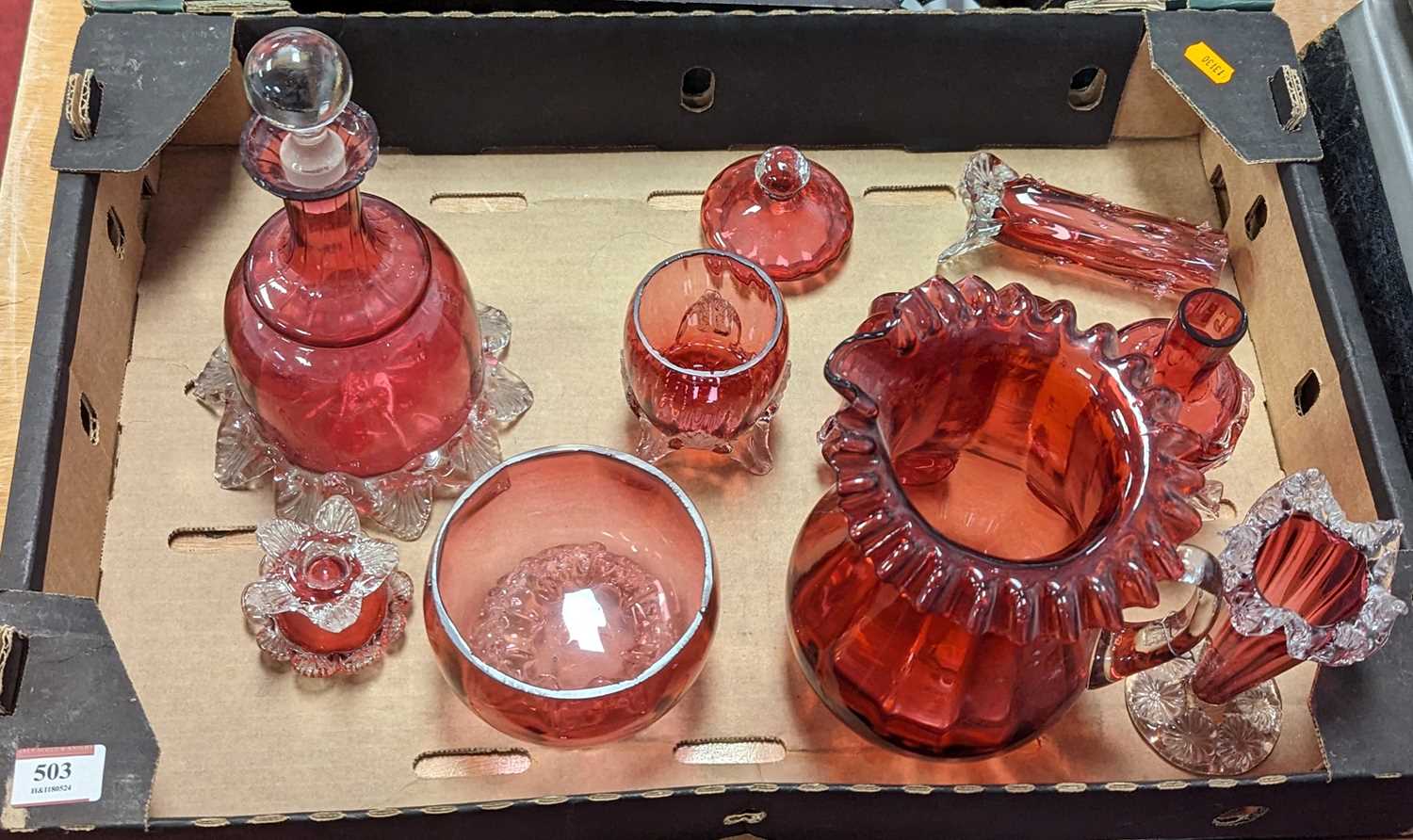 A collection of cranberry glass ware to include a mallet shaped decanter and stopper, and spill