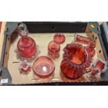 A collection of cranberry glass ware to include a mallet shaped decanter and stopper, and spill