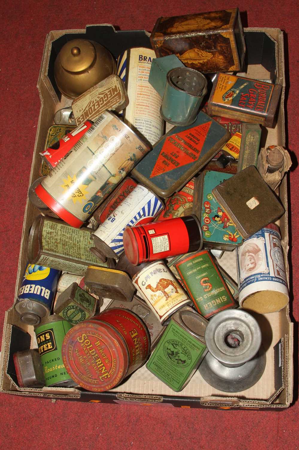 A collection of vintage tins and moneyboxes to include Baker's Solderine and Thorne's Cream Toffee