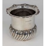 A late Victorian silver bowl, having a shaped rim to a cylindrical body and wrythen moulded base,