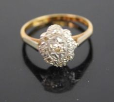 An Art Deco 18ct gold and platinum diamond tablet ring, the oval flower head setting centre set with