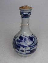 A Chinese blue & white glazed bottle vase, decorated with a pagoda within mountain landscape, height