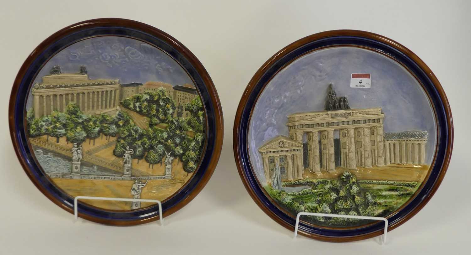 A pair of German pottery wall plates, each relief decorated with architectural scenes of Berlin,
