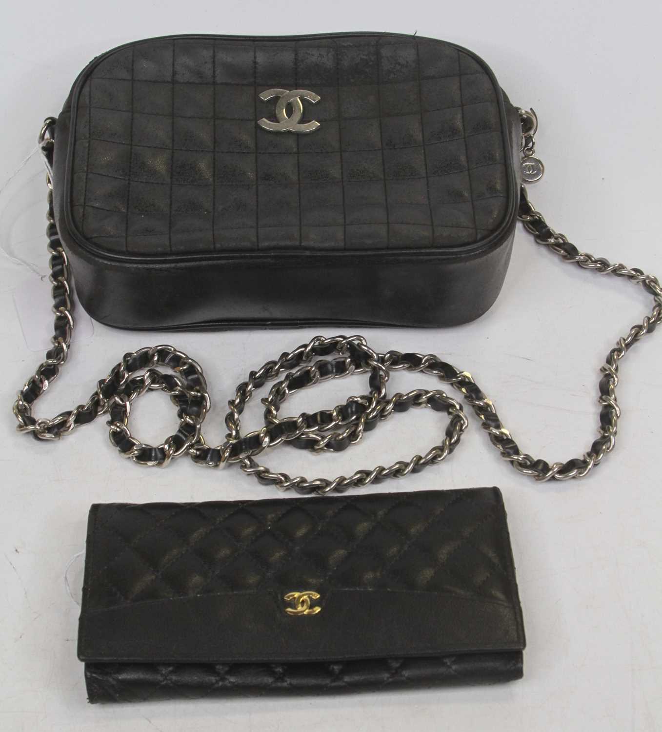 After Chanel - a lady's quilted handbag, with applied metal logo, suspended from a chain, w.21cm;