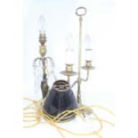 A figural metal table lamp having glass droplets and standing upon a polished hardstone plinth,