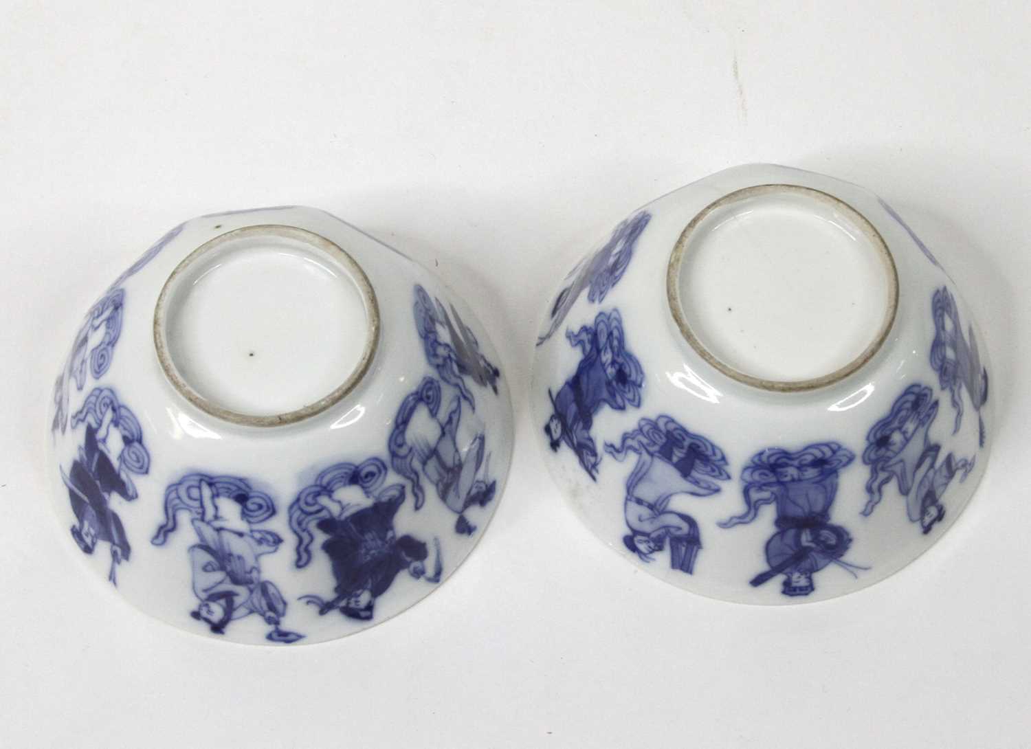 A pair of Chinese blue & white glazed porcelain teabowls, each underglaze decorated with figures, - Image 2 of 2