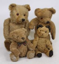 A vintage blond mohair teddy-bear, having glass eyes and posable limbs, h.33cm; together with