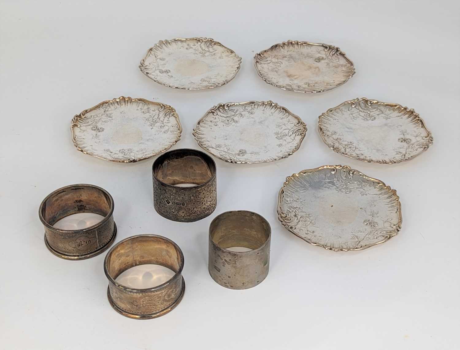 A set of six French silver dishes, each of shaped circular form with raised rim embossed with