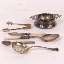 A collection of metalware, to include a pair of silver sugar nips, silver strainer spoon, silver