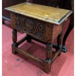 A moulded oak needlework box, modelled as an oak joint stool with carved frieze and hinged cover,