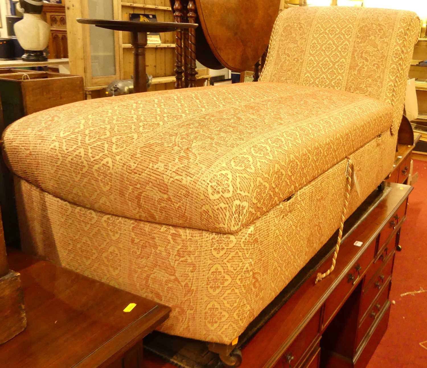 A cream and red floral striped fabric upholstered boxbase day-bed, having removable domed seat, on