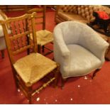 An Edwardian walnut framed and blue floral fabric upholstered tub chair, together with a ladder back