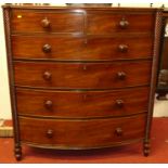 A Regency mahogany bowfront chest, of two short over four long graduated drawers within spiral