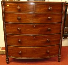 A Regency mahogany bowfront chest, of two short over four long graduated drawers within spiral