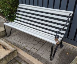 A black painted wrought iron ended and painted teak slatted three-seater garden bench, width 153cm