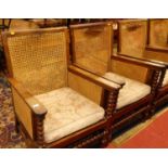 A pair of early 20th century indigenous hardwood and cane bergere chairs, raised on bobbin turned