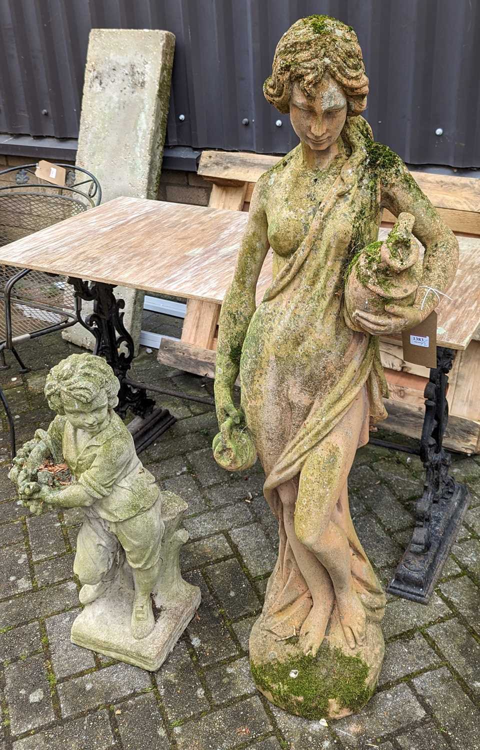 A weathered terracotta garden statue of a semi-nude robed classical maiden, height 130cm, together