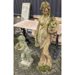 A weathered terracotta garden statue of a semi-nude robed classical maiden, height 130cm, together
