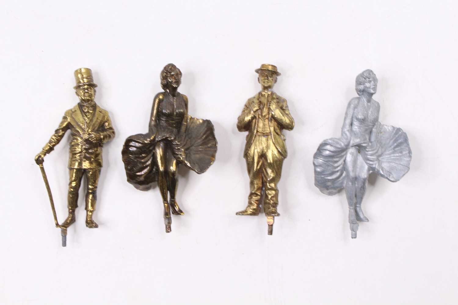 A collection of cast metal Lonestar products, figurines of Marilyn Monroe, Charlie Chaplin, and WC