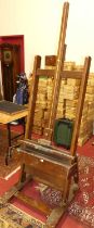 A large stained wood freestanding adjustable artists easel