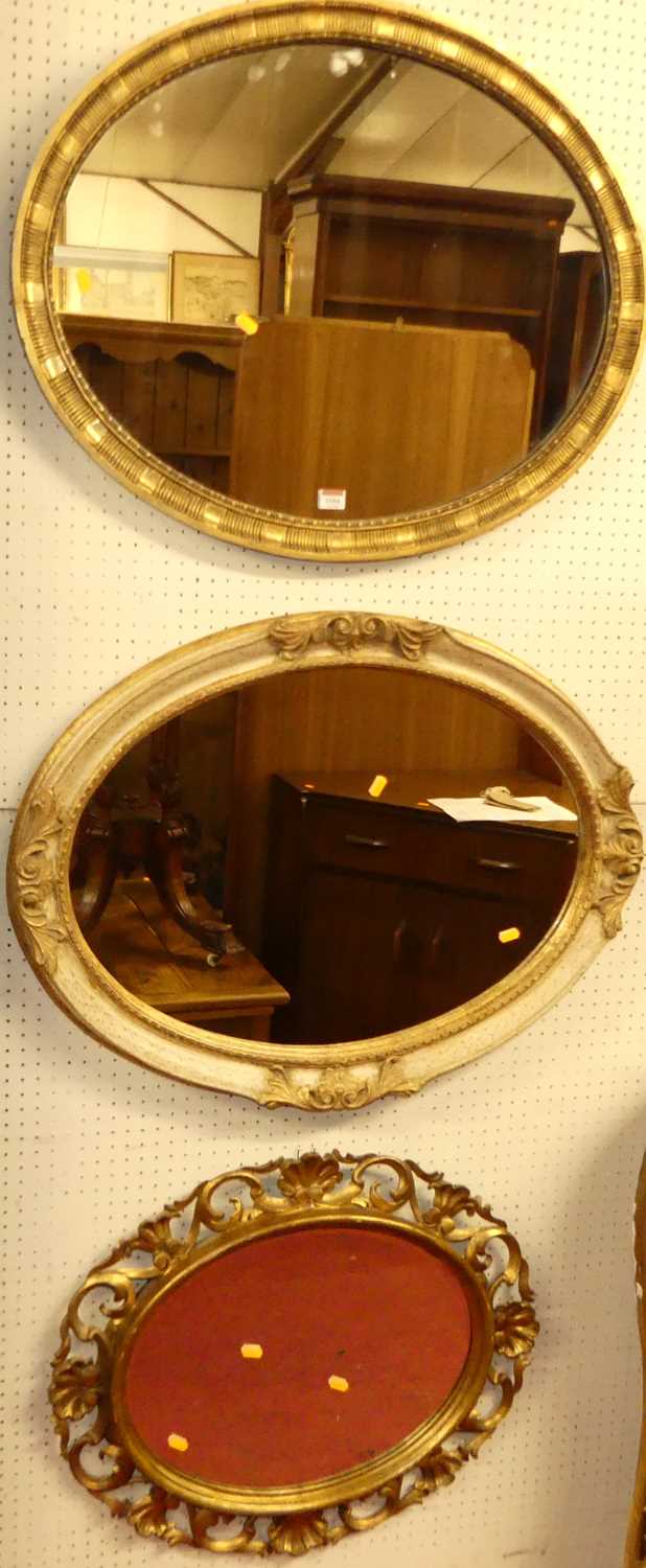 An early 20th century gilt framed oval wall mirror, 64 x 79.5cm; together with a contemporary