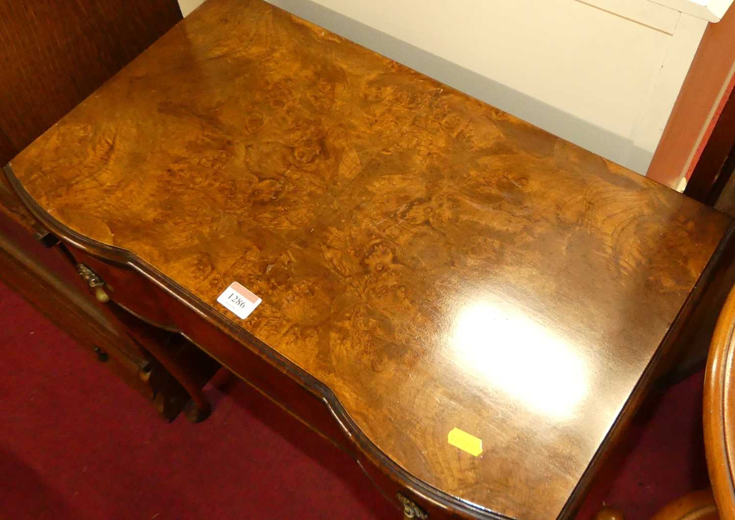 A 1930s figured walnut serpentine single drawer side table, raised on shell capped cabriole - Image 2 of 4