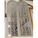 A pair of wooden framed garden mirrors, with wrought metal grilles, each 122x40cm