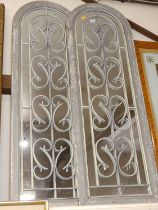 A pair of wooden framed garden mirrors, with wrought metal grilles, each 122x40cm