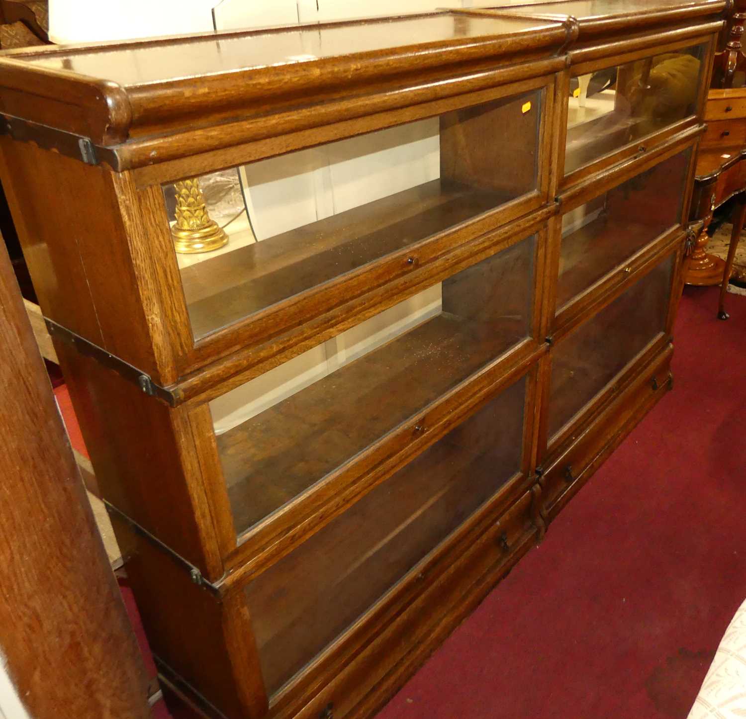 A pair of 1930s oak Globe Wernicke three-tier stacking bookcases, each with single long lower drawer