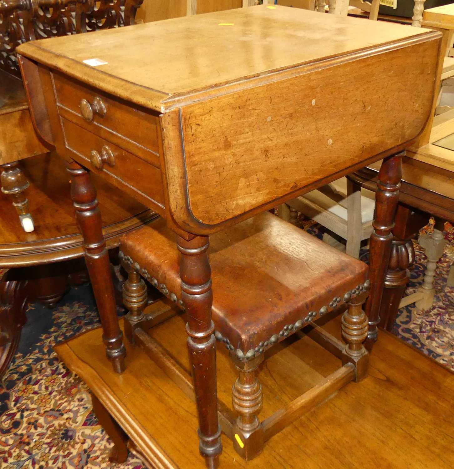 A mid-Victorian figured walnut three-division Canterbury, having single lower drawer on turned