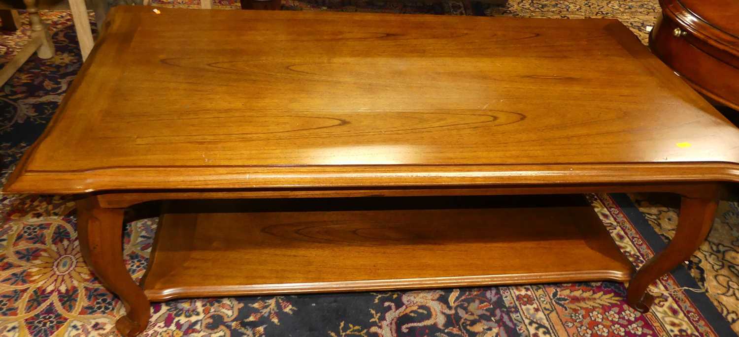 A contemporary cherry wood oval coffee table, with single frieze drawer and platform undertier,