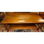 A contemporary cherry wood oval coffee table, with single frieze drawer and platform undertier,