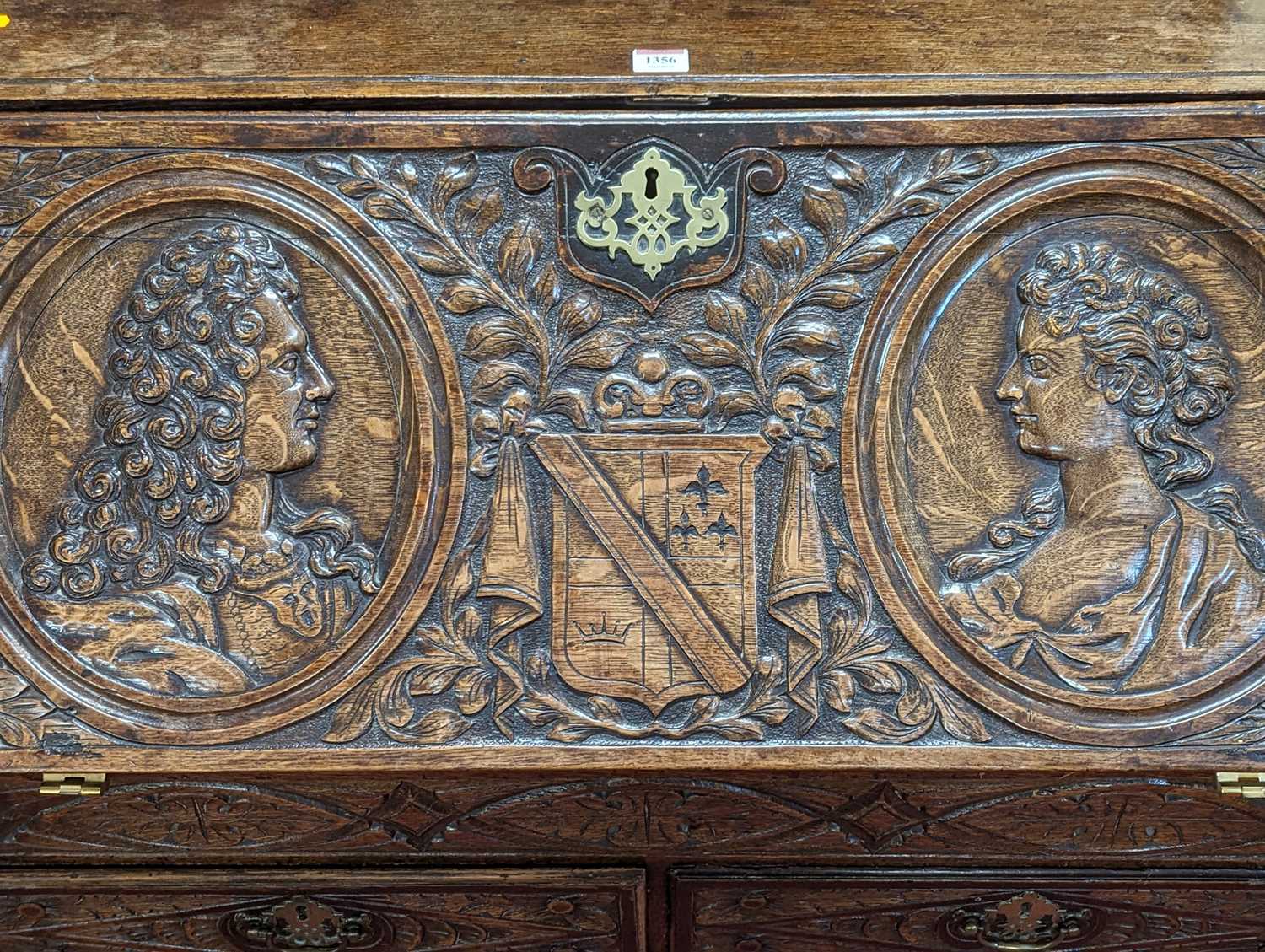 A 19th century relief carved oak slopefront writing bureau, having a fitted interior over two - Image 2 of 3