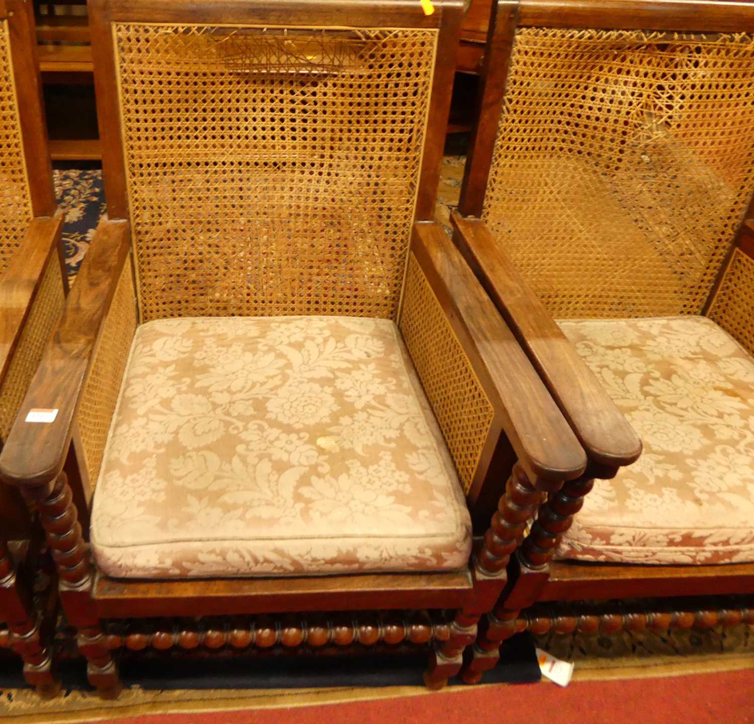 A pair of early 20th century indigenous hardwood and cane bergere chairs, raised on bobbin turned - Image 2 of 6