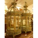 A pair of verdigris metal and glass inset domed hanging lanterns, each in the Eastern taste, h.59cm