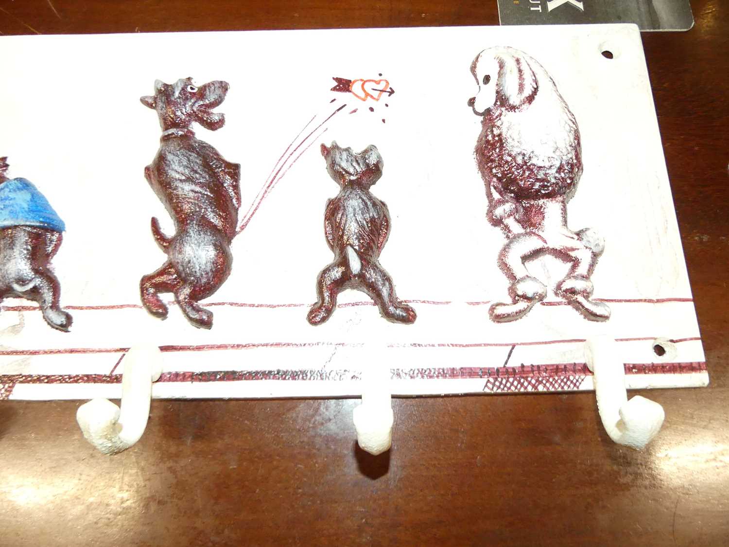 A contemporary painted cast metal wall mounted set of seven hat-hooks, displaying novelty peeing - Image 4 of 4