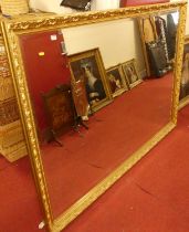 A large contemporary floral gilt decorated bevelled rectangular wall mirror, 138.5 x 196.5cm