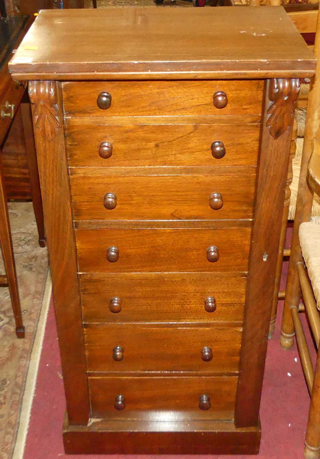 A Victorian walnut Wellington chest, having seven graduated drawers, turned knob handles and locking